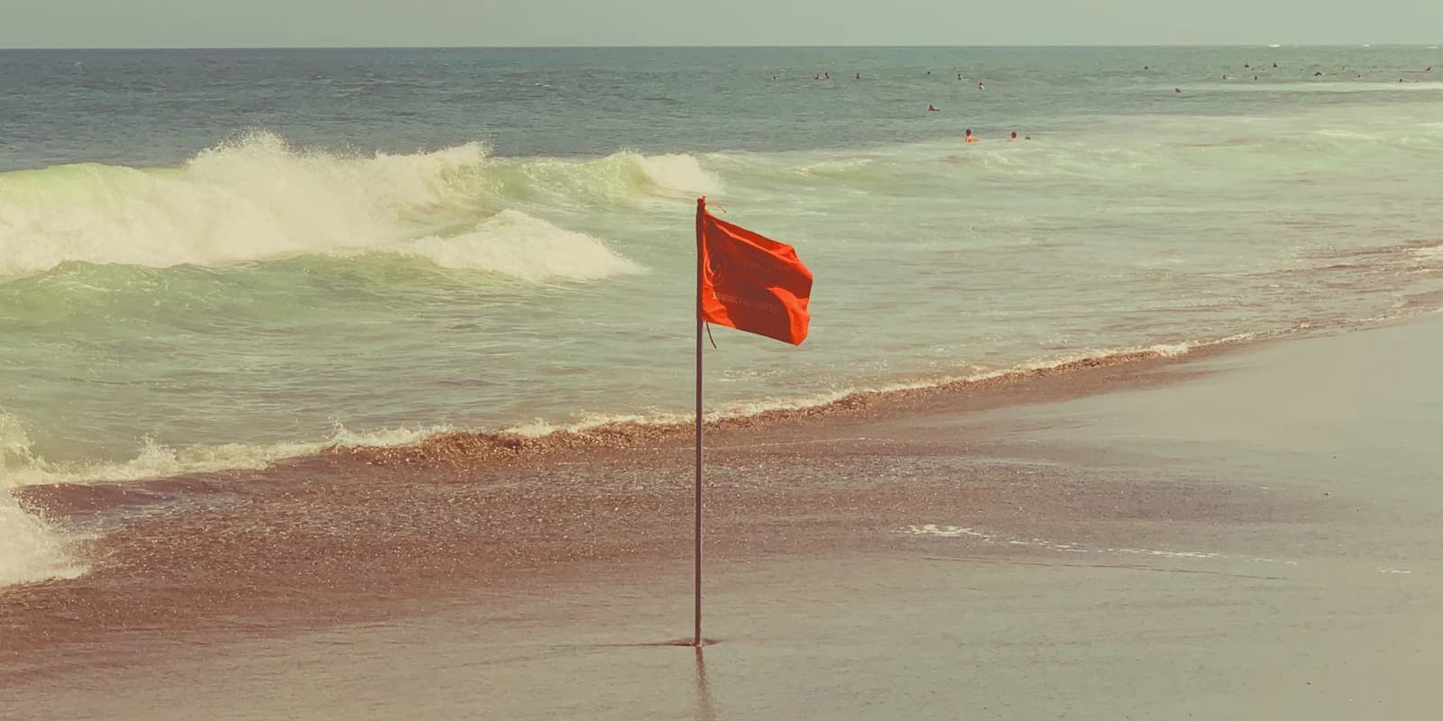 A red warning flag on a beach